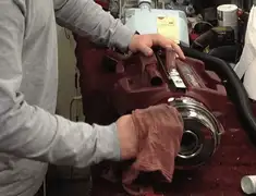Vacuum repair technician cleaning and servicing a vacuum motor in Sioux Falls, SD